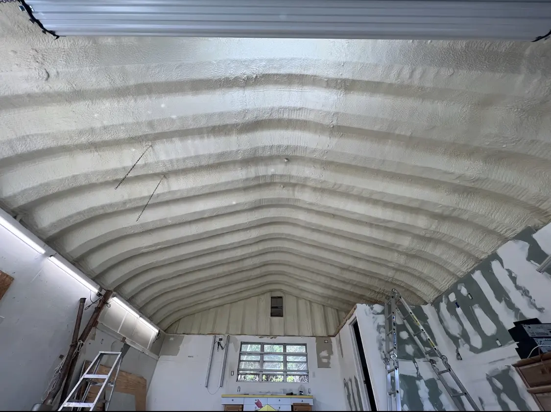 Spray polyurethane foam applied to the underside of a metal roof deck in Smithtown